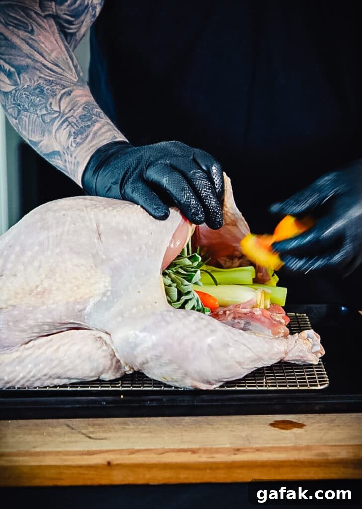 How to Smoke a Turkey: Step-by-Step Guide for Juicy Results 6 stuffing a smoked turkey with veggies and herbs
