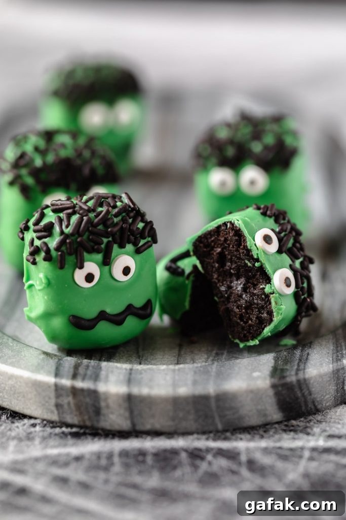 chocolate cookie truffle with green candy coating and eyes