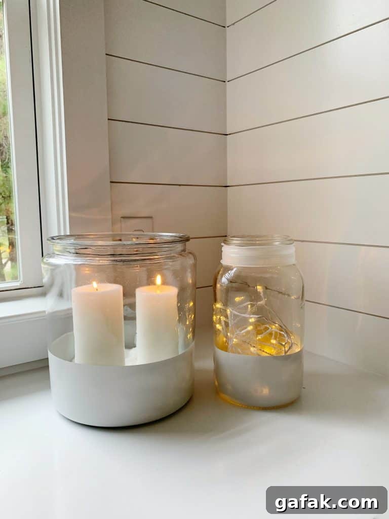 2 color blocked jars with lit candles inside