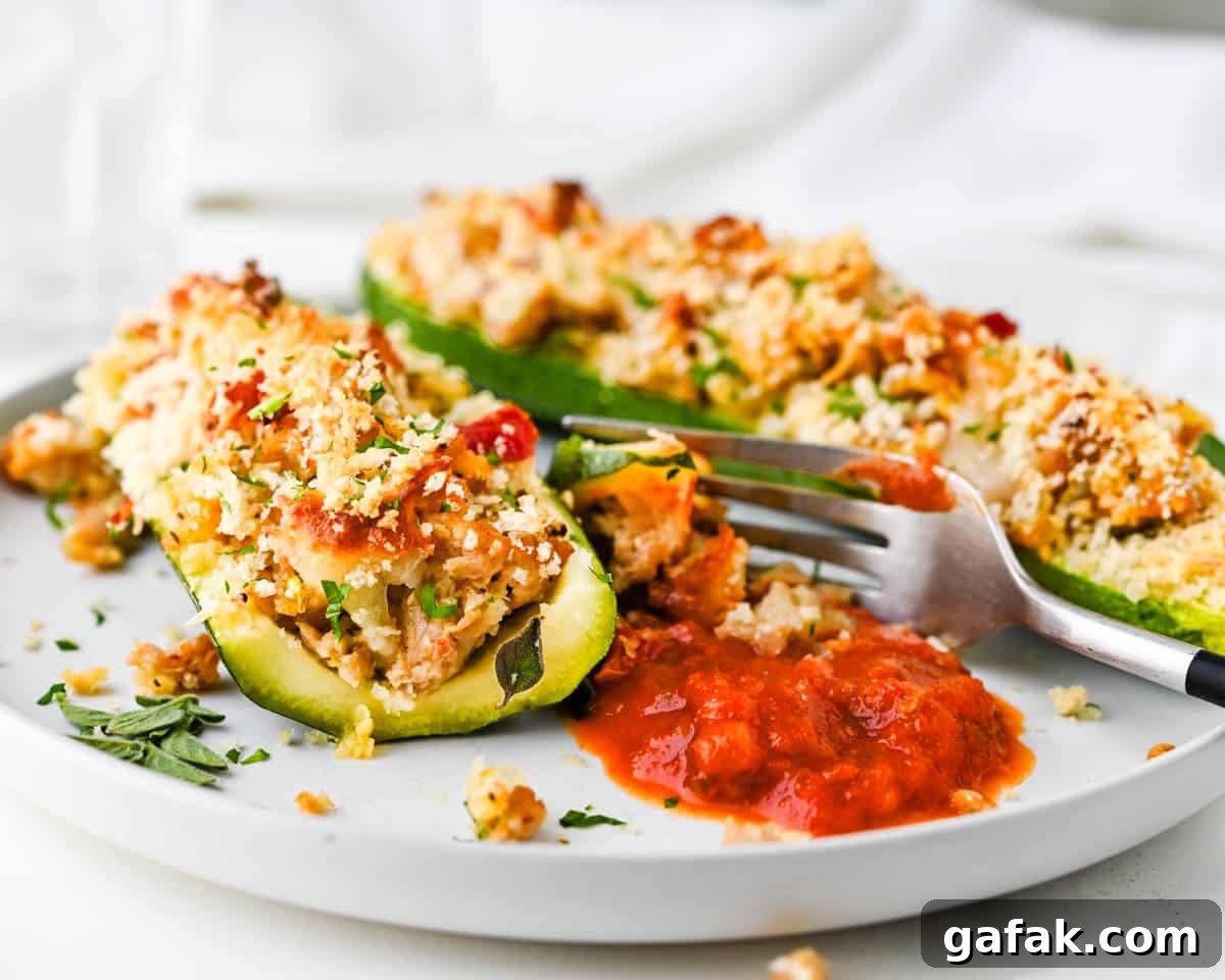 Dunking stuffed squash into marinara sauce.