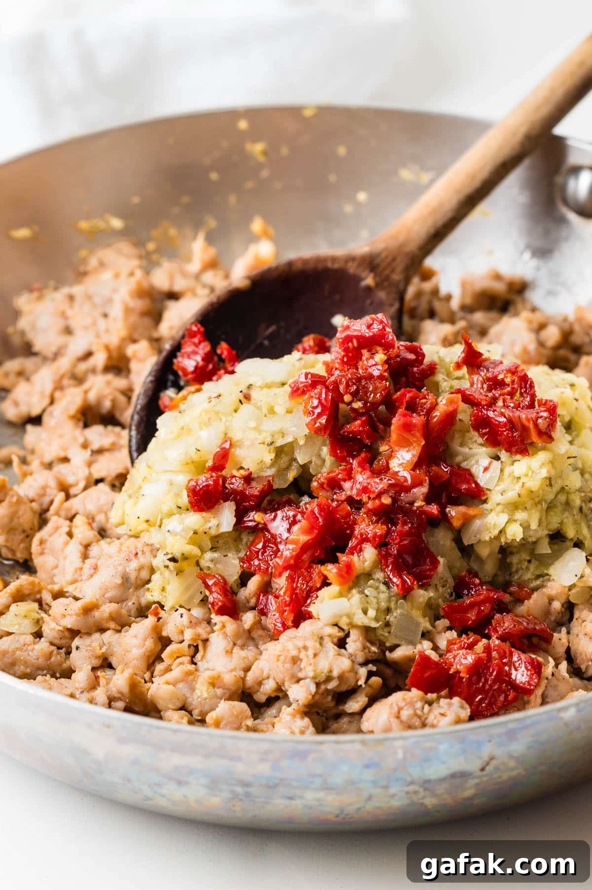 Adding chopped sun-dried tomatoes. 