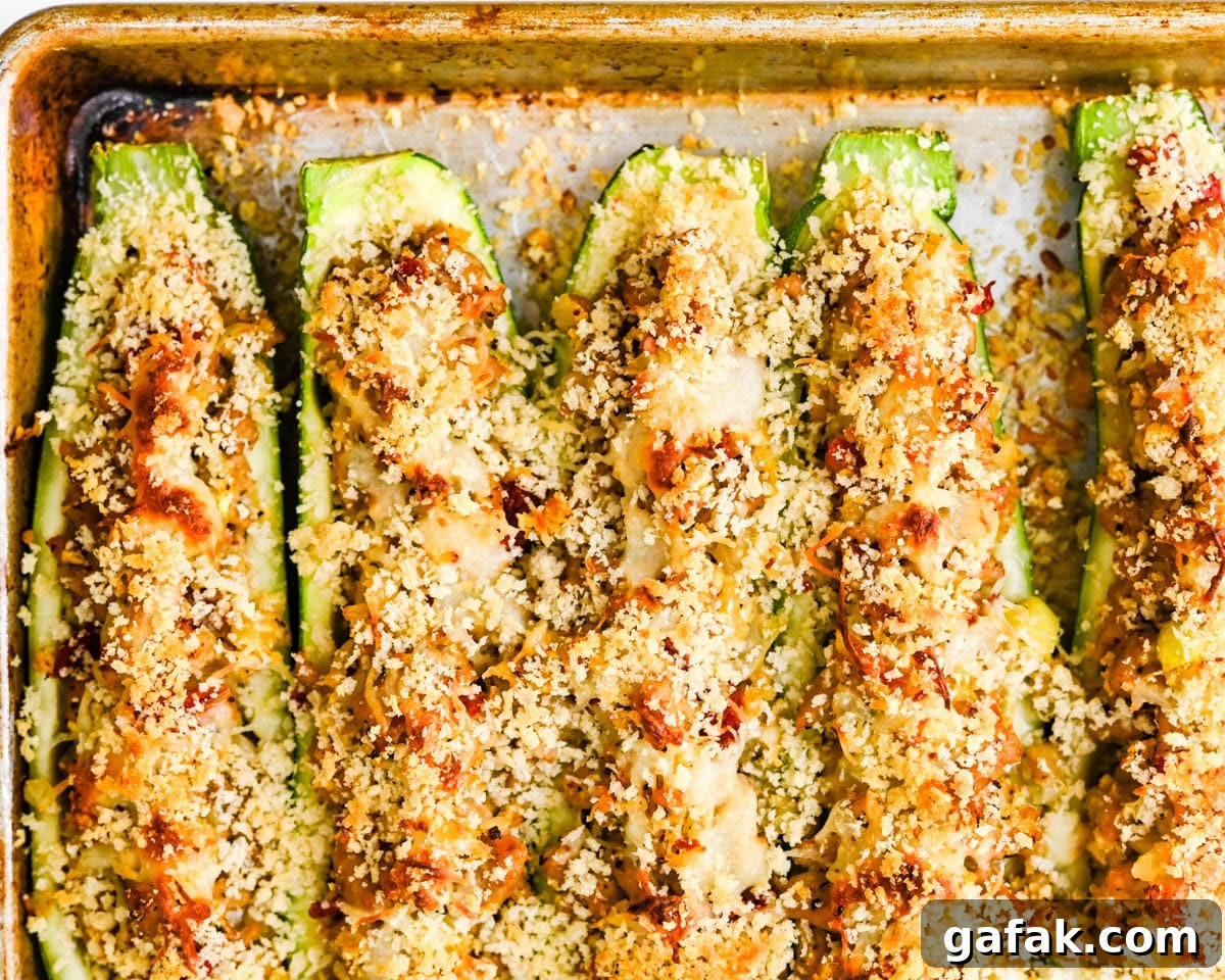 A sheet pan of baked stuffed zucchini.