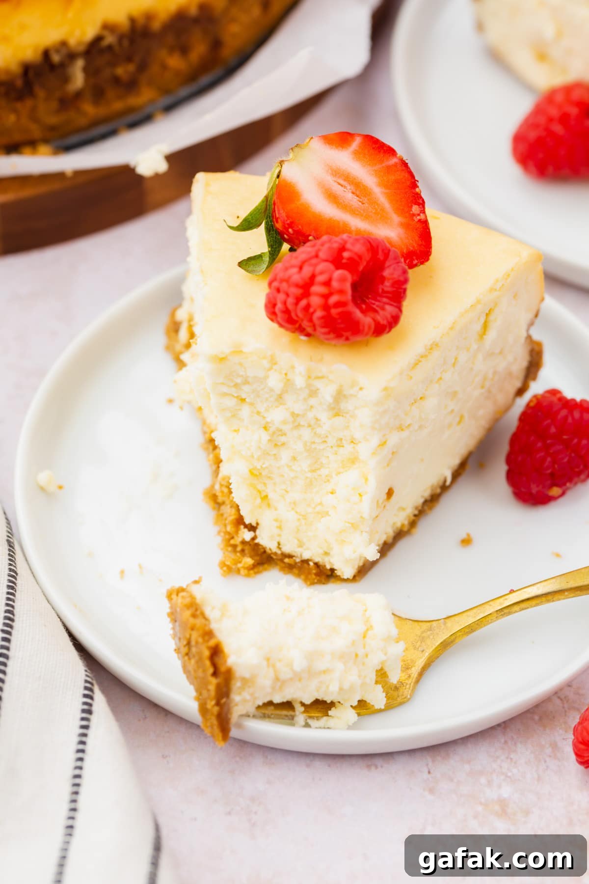 A slice of gluten-free cheesecake topped with red berries.