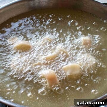 Calamari frying in hot oil.
