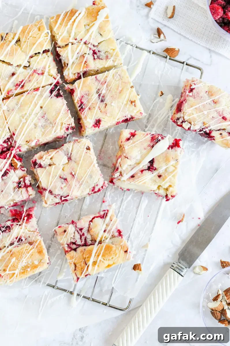 An overhead picture of white chocolate and raspberry blondies on a metal cooling rack.