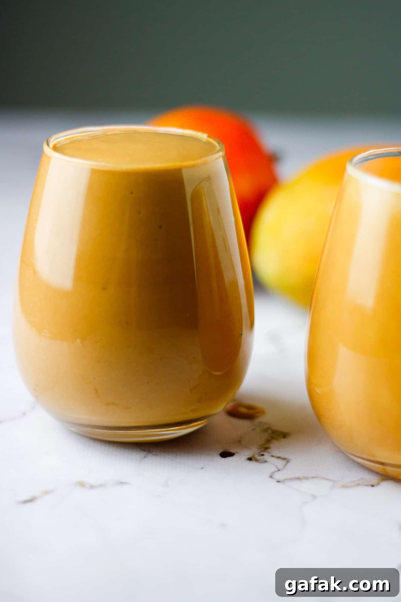 Chocolate Mango Smoothie Recipe for Creamy Tropical Shakes 3 Two glasses of chocolate mango smoothie filled to the brim
