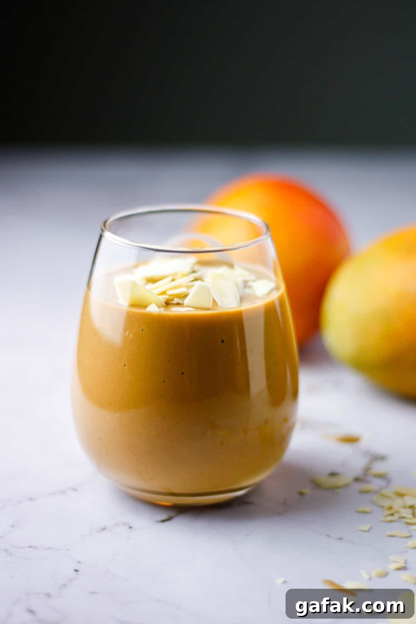 Chocolate Mango Smoothie Recipe for Creamy Tropical Shakes 5 A glass of chocolate mango smoothie topped with sliced almonds
