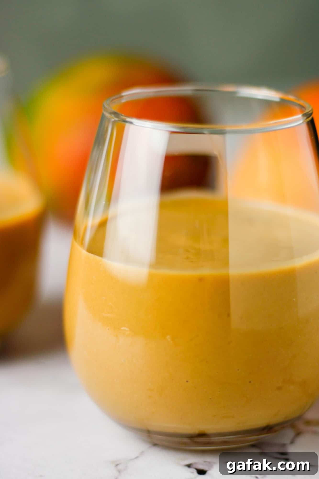 Chocolate Mango Smoothie Recipe for Creamy Tropical Shakes 6 Up close view of a glass of chocolate mango smoothie on the table