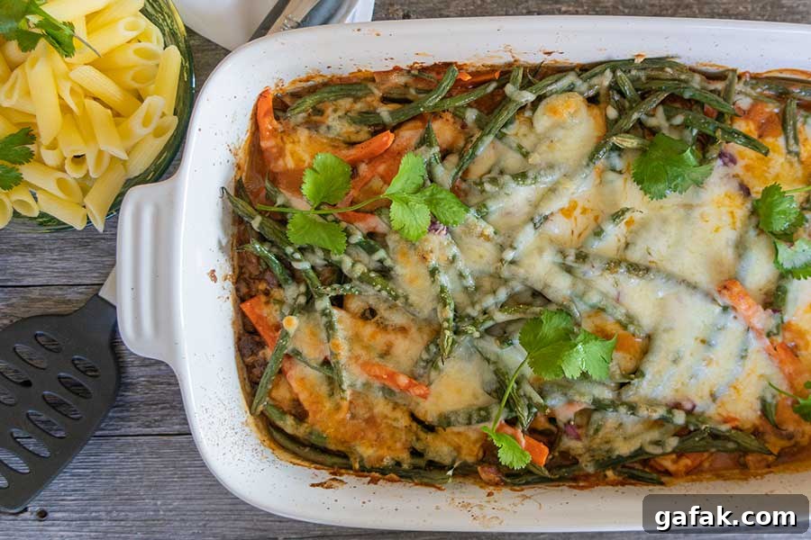 baked cheesy ground beef and green beans in a casserole dish