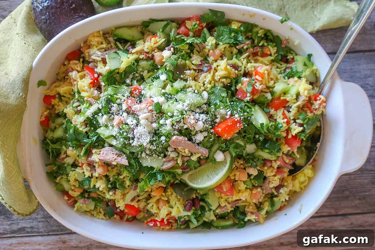 Mexican beef and rice salad with toppings in a serving dish