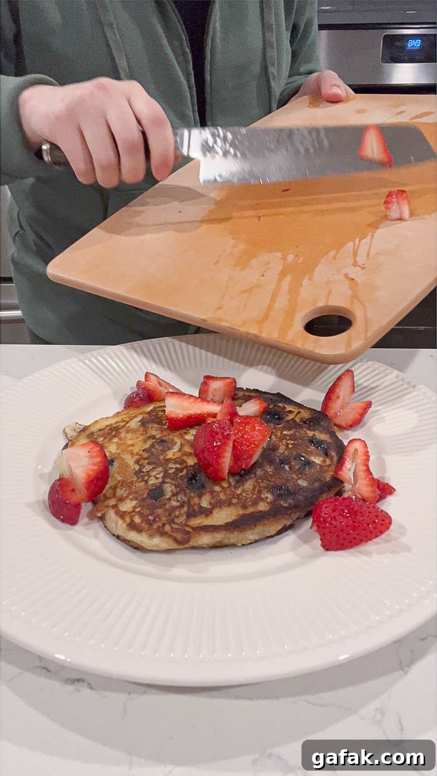 Topping Strawberries on Apple Pancakes