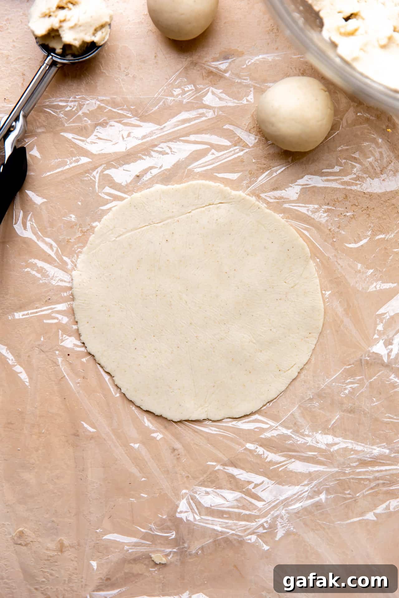 Corn tortilla masa dough pressed into a circle for cooking. 