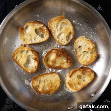 Bread being toasted in frying pan.