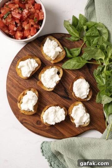 Toast on a cutting board topped with ricotta.