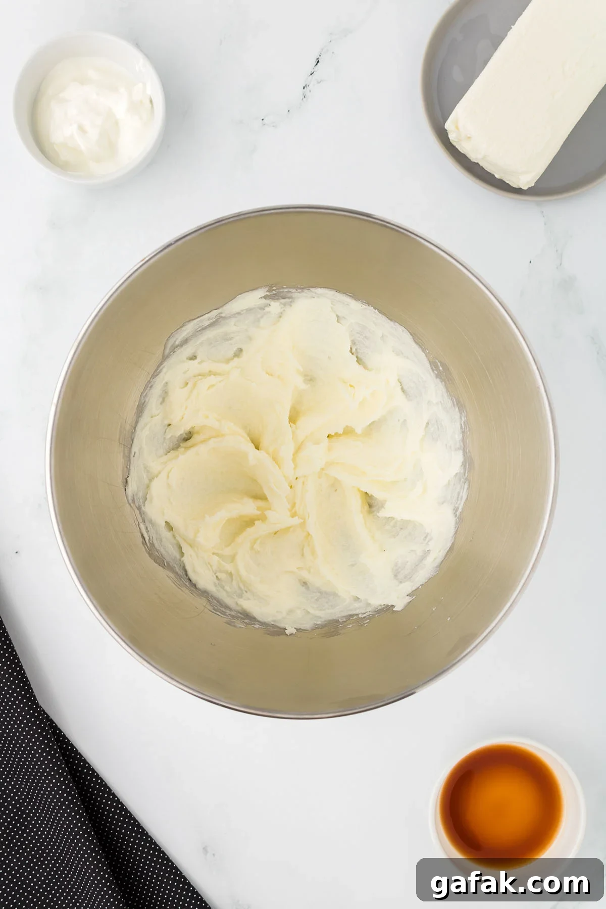 Butter and sugar are beaten together in a mixing bowl.