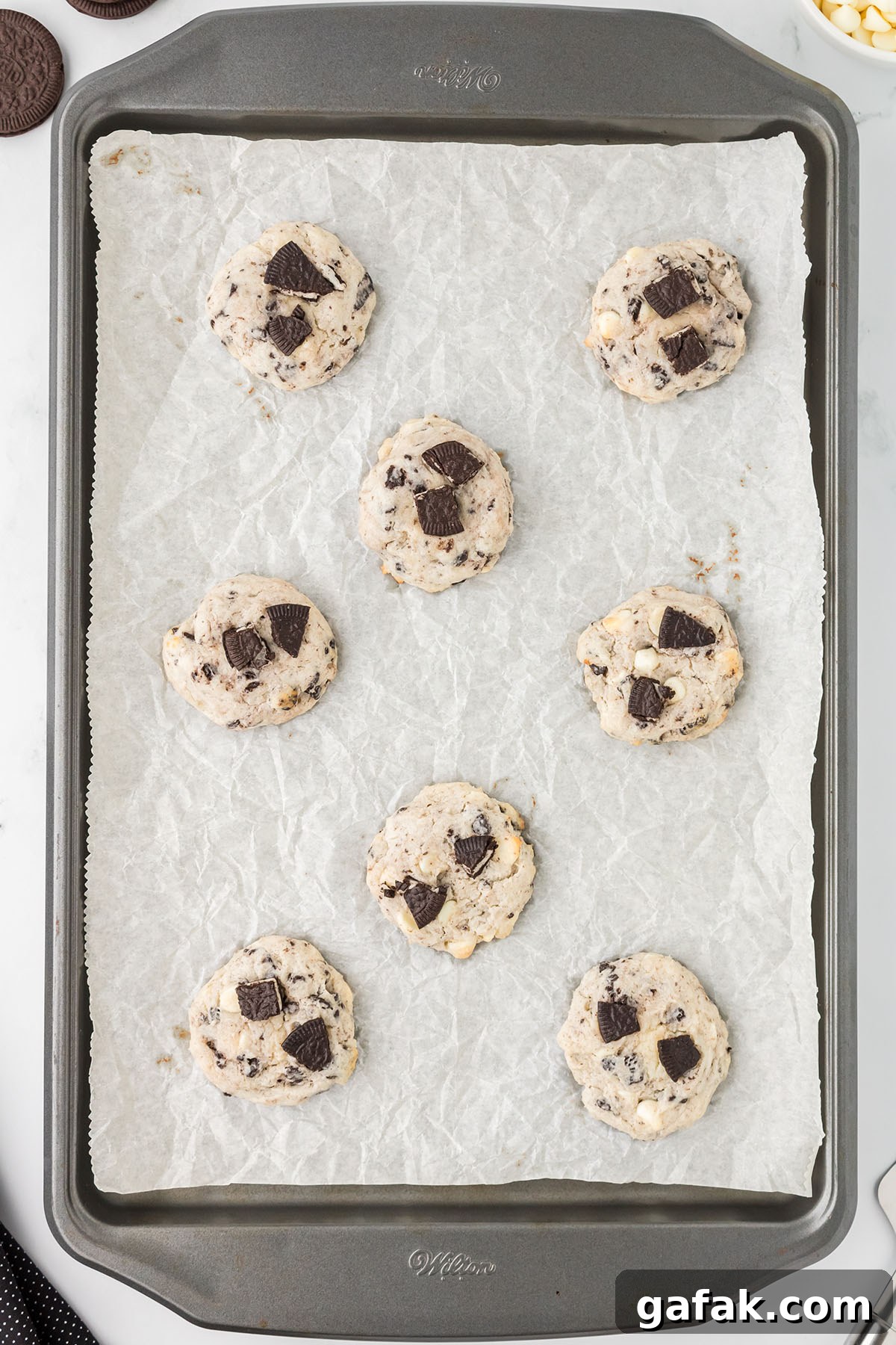 Baked cookies on a parchment paper lined baking sheet.