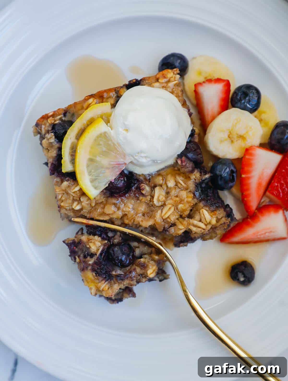 Fork cutting through a piece of blueberry oatmeal bake 
