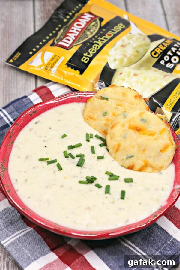 a bowl of potato soup served with cheddar biscuits with a soup package in the background.