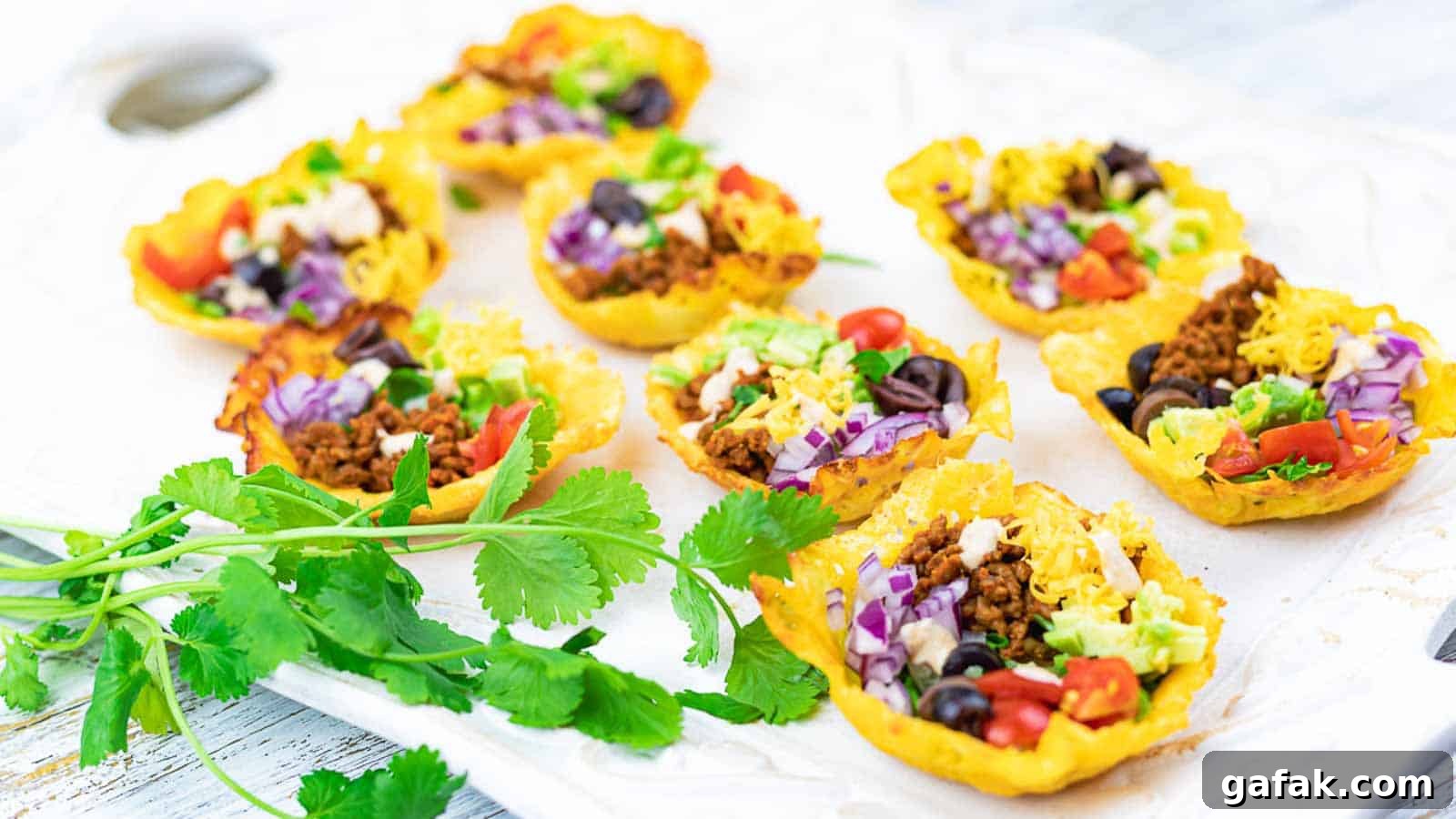 21 Packed Lunch Ideas to Make Midday Meals Exciting Again 16 Easy Crunchy Keto Taco Cups on a white board with cilantro.
