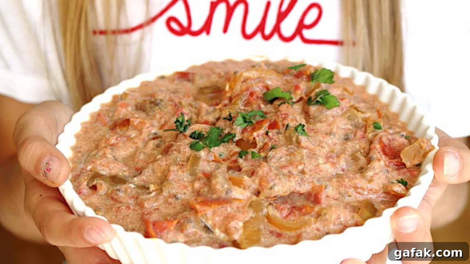 21 Packed Lunch Ideas to Make Midday Meals Exciting Again 18 A girl holding a big casserole filled with vegetable stew.