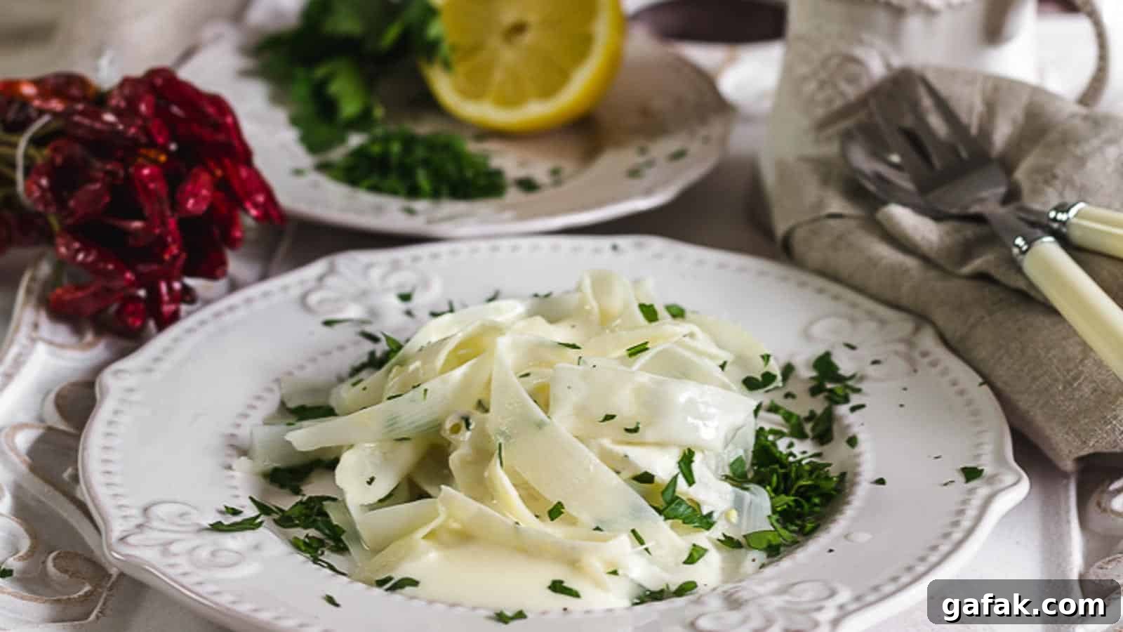 21 Packed Lunch Ideas to Make Midday Meals Exciting Again 4 A white plate filled with asparagus pasta and sauce.