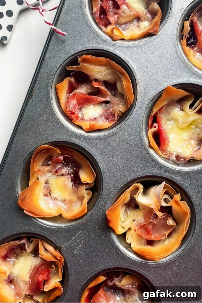Baked brie filo bites in a mini muffin tin.