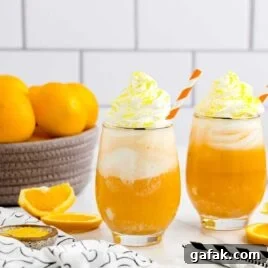 a close up shot of Orange Creamsicle Cocktails in a glass
