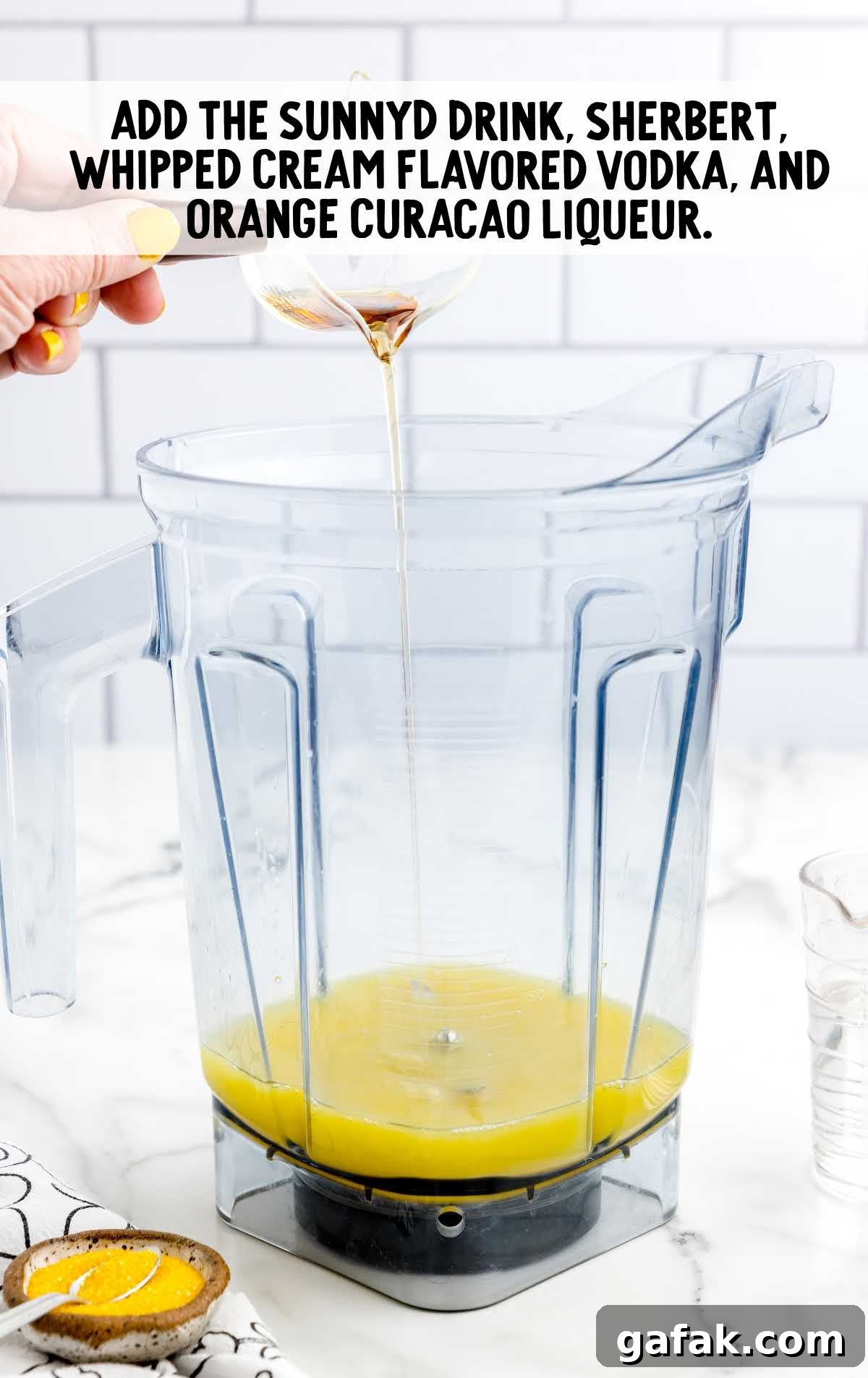 sunnyd drink, sherbert, whipped cream flavored vodak, and orange curacao liqueur added in a blender
