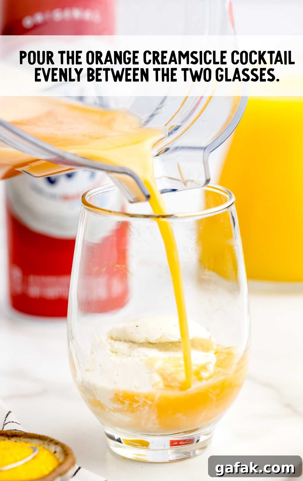 Orange Creamsicle Cocktail poured into a glass