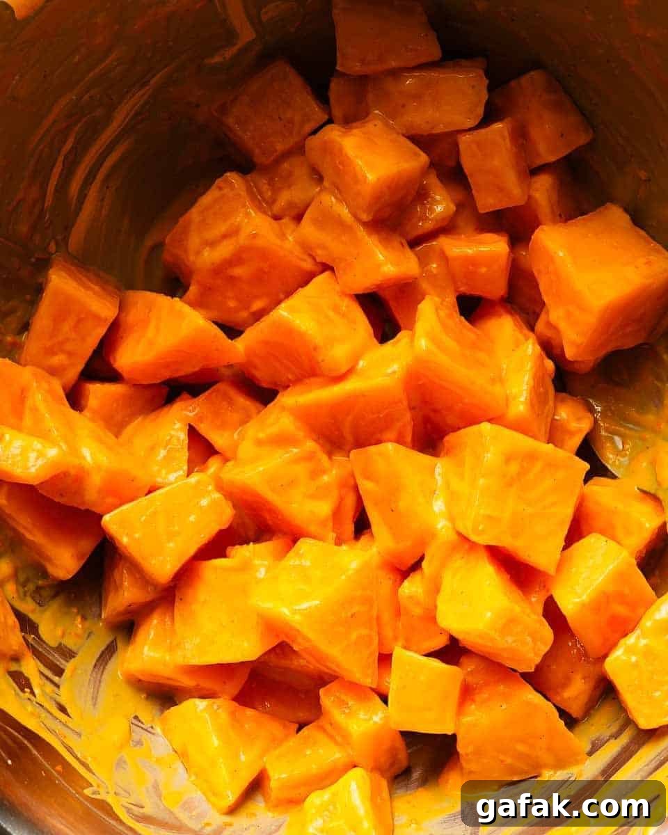 Cubed orange melons in a bowl with a glossy coating.