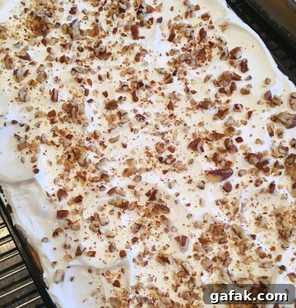 Creamy Layered Pumpkin Dessert with Gingersnap Crust 9 pumpkin-lush-adding-topping