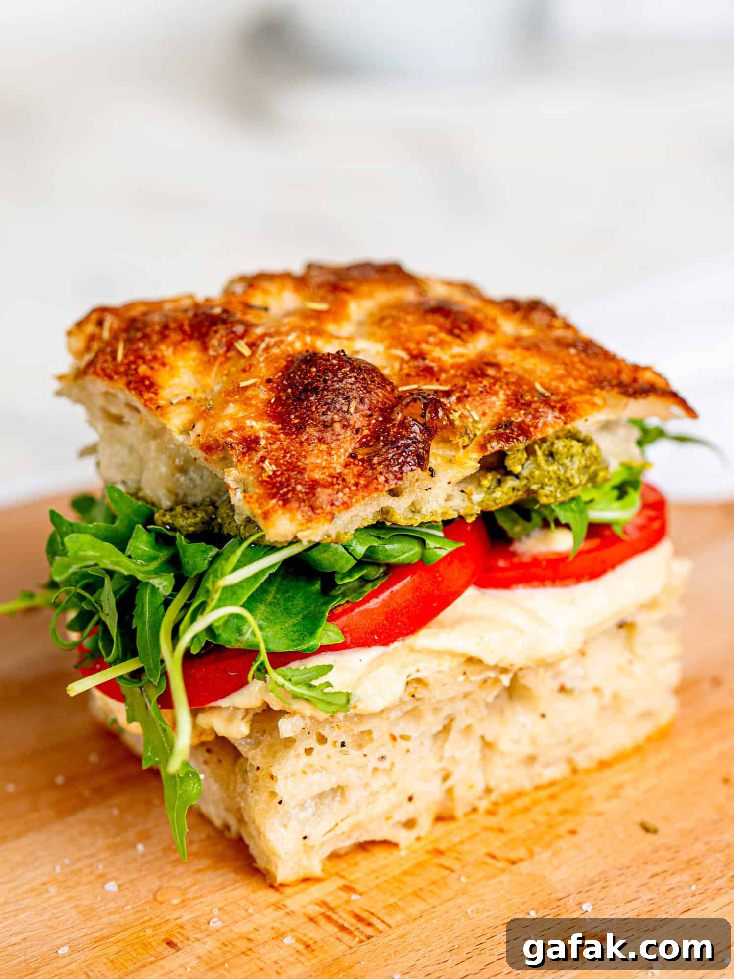 Focaccia sandwich with cottage cheese hummus, tomatoes, rocket and pesto.