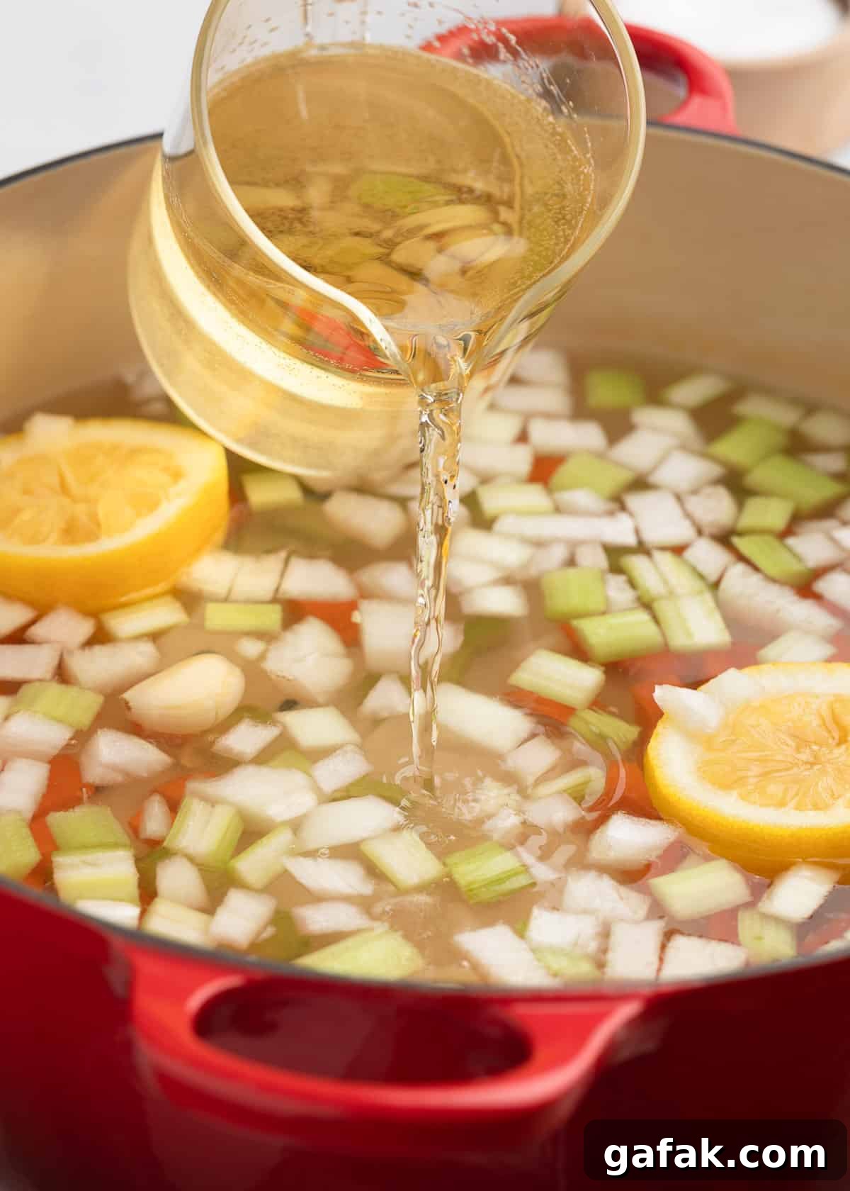 How to Poach Shrimp Perfectly Every Time 4 pouring white wine into a pot with vegetables