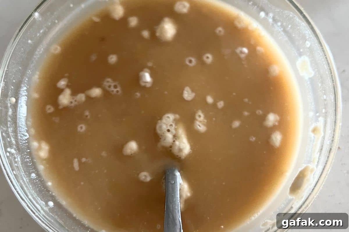 Flour and beef broth combined in a bowl