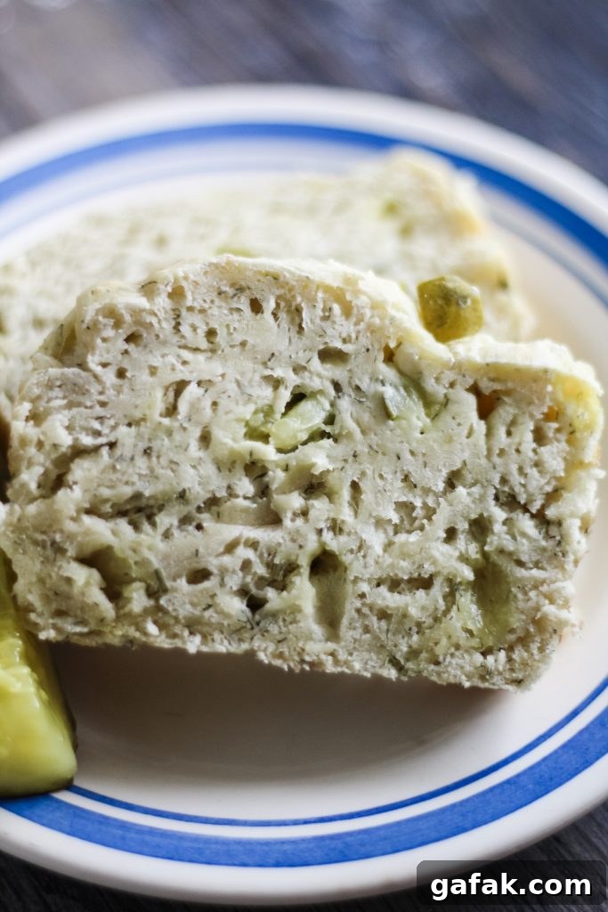 a slice of dill pickle bread on a blue rimmed white plate