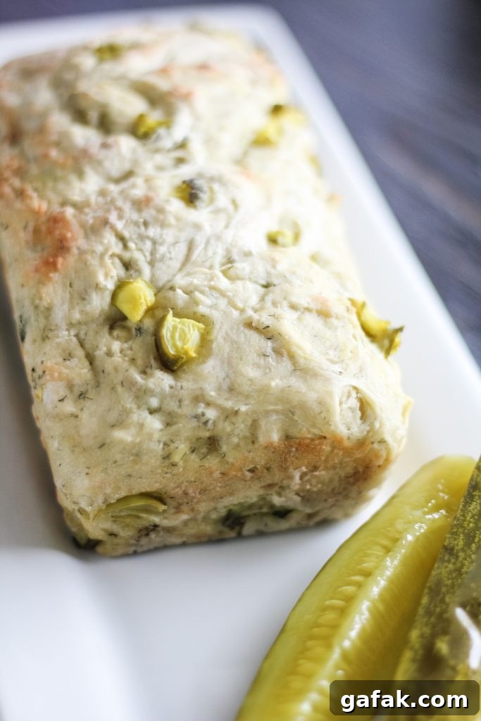 a loaf of dill pickle shown on a white serving platter