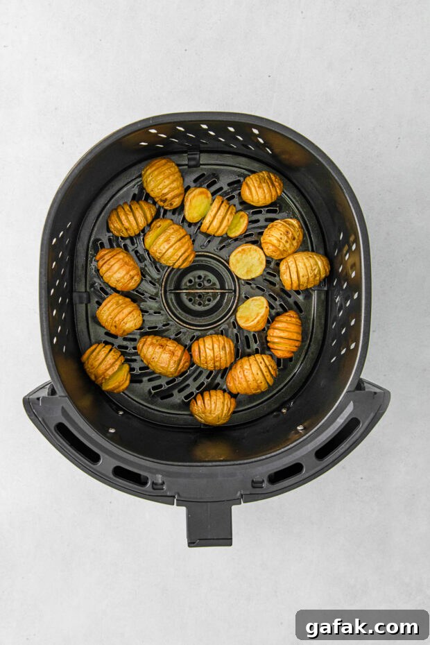 Air Fryer Hasselback Potatoes cooked in the air fryer basket. 