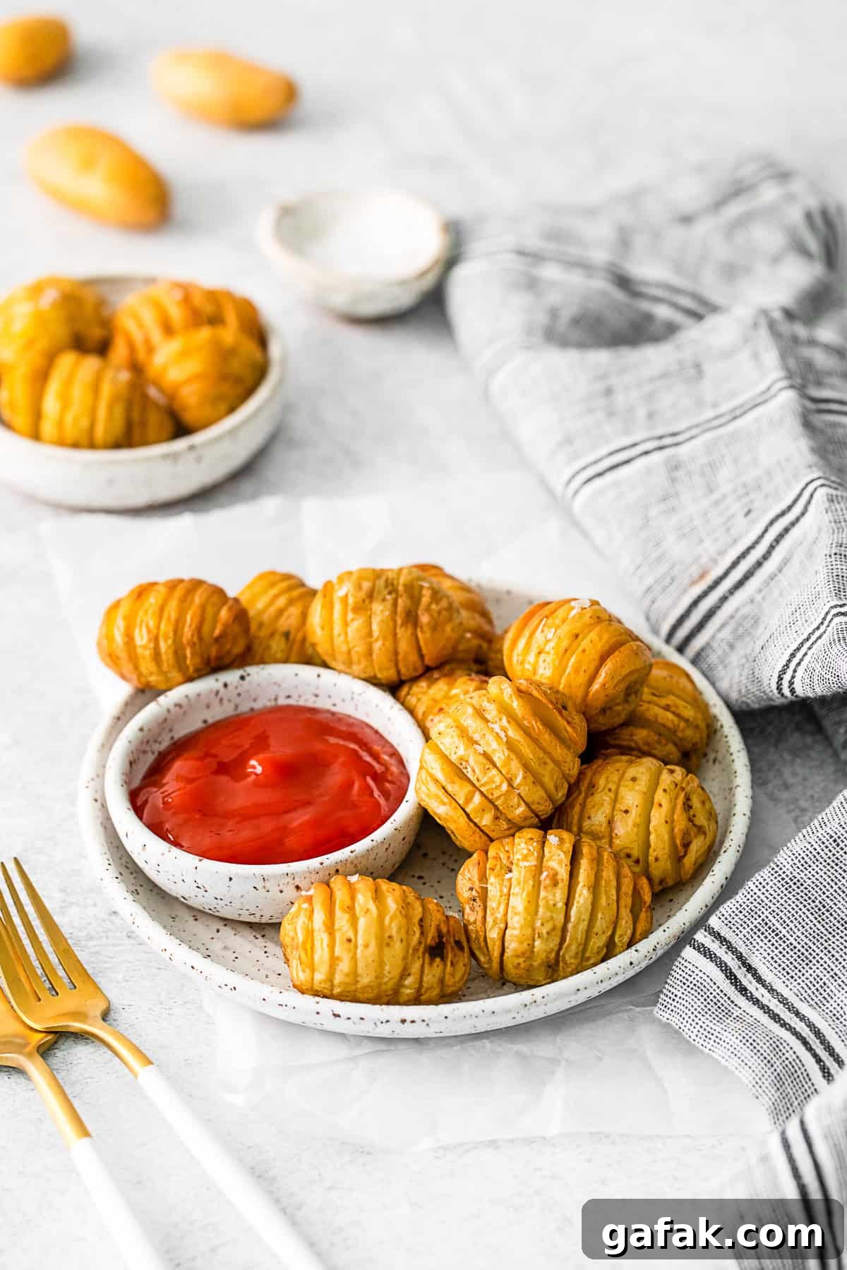 Air Fryer Hasselback Potatoes on a small plate. 