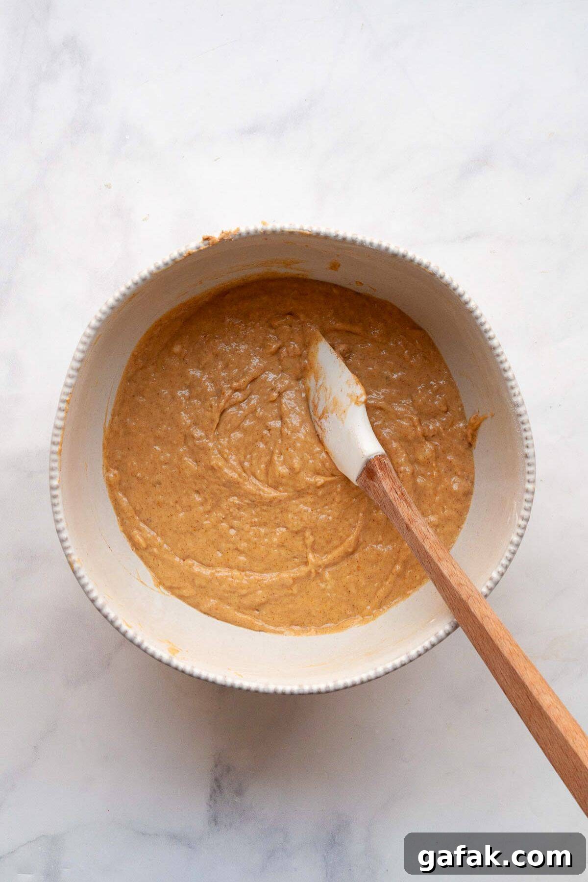 Moist Dairy-Free Banana Bread Recipe (Vegan-Friendly) 5 Dairy-free banana bread batter in a mixing bowl, made with coconut oil and mashed bananas.