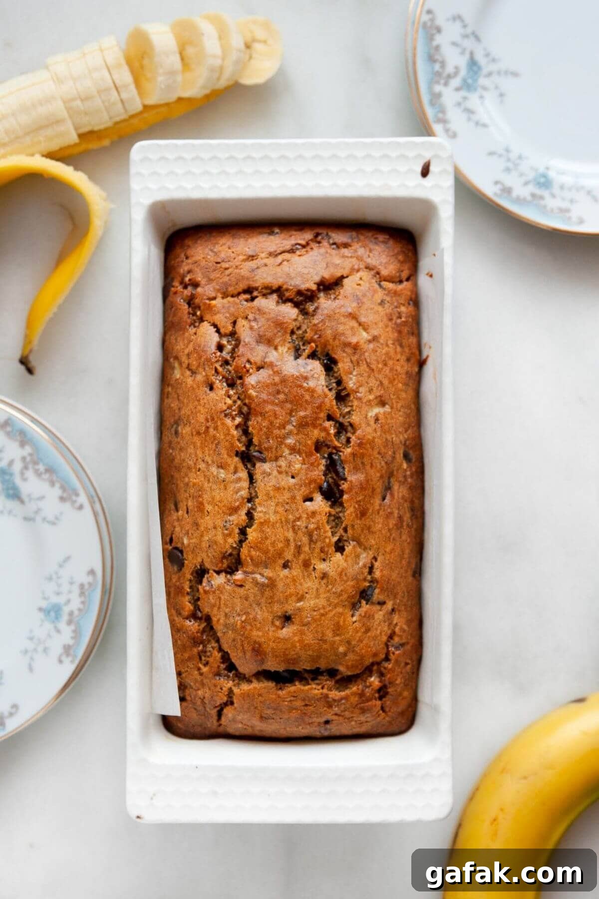 Moist Dairy-Free Banana Bread Recipe (Vegan-Friendly) 7 Freshly baked dairy-free banana bread loaf cooling in a parchment-lined loaf pan.