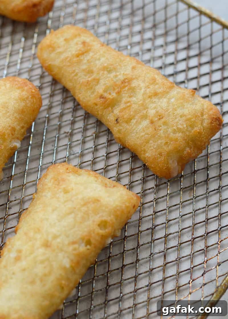 Crispy Air Fryer Fish Tacos with Lime Slaw 3 crispy frozen fish fillets on an air fryer rack