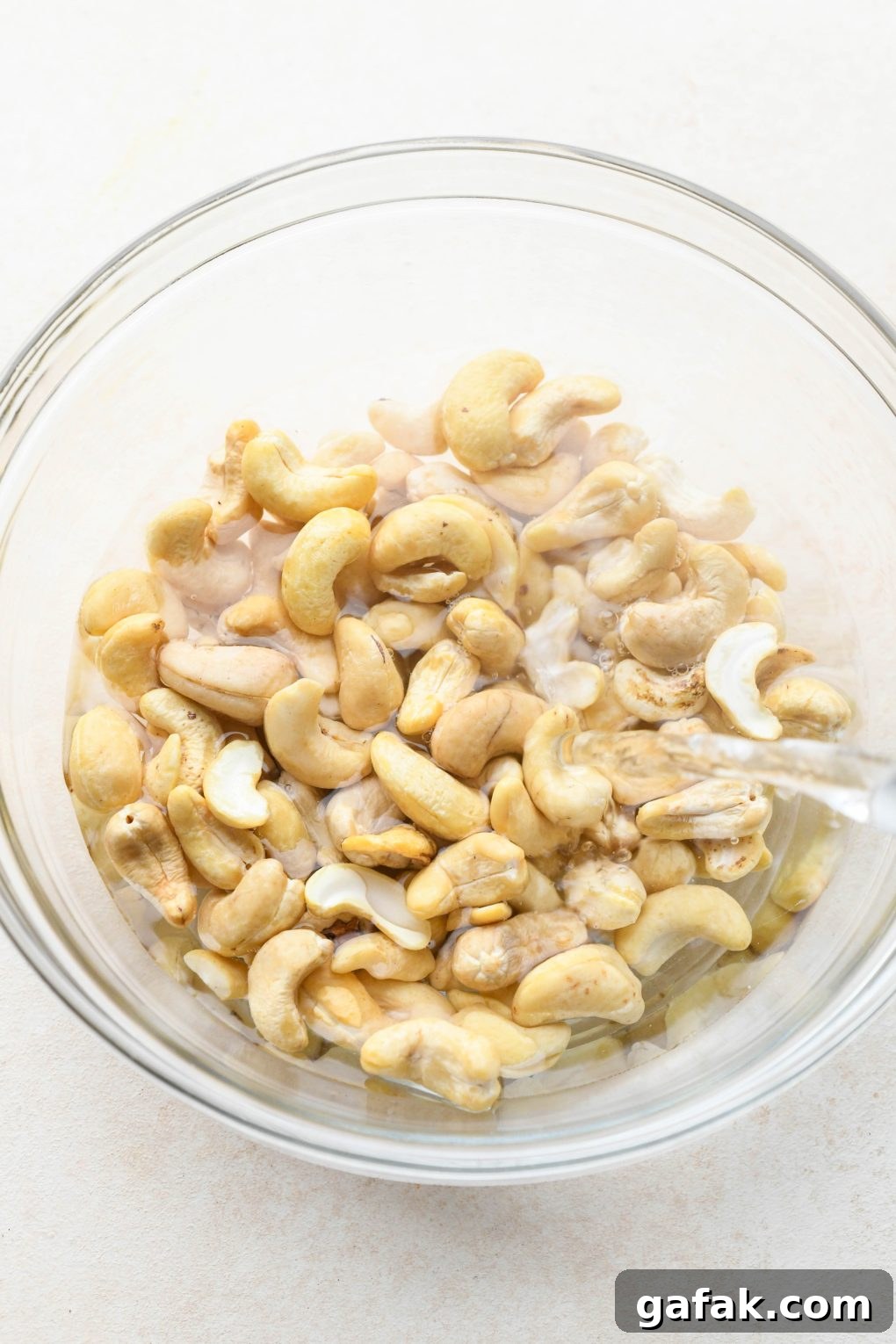 How to make Dairy Free Queso Fundido with Ground Beef: Soaking raw cashews in hot water.