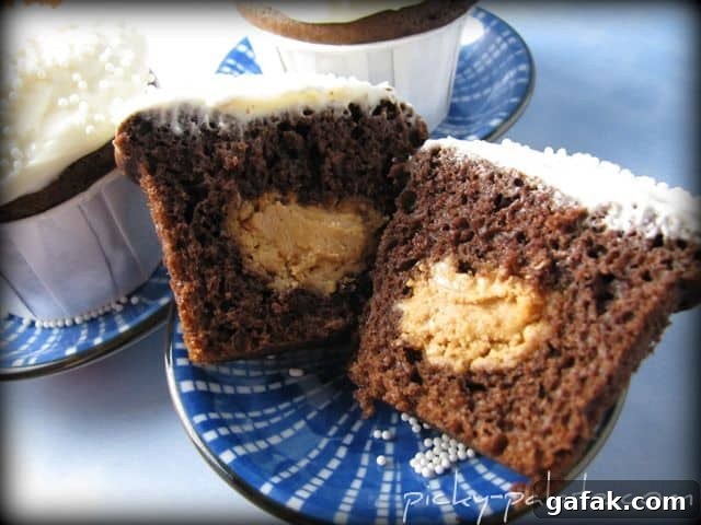 A Peanut Butter Filled Chocolate Cupcake Cut in Half to Show the Filling Inside