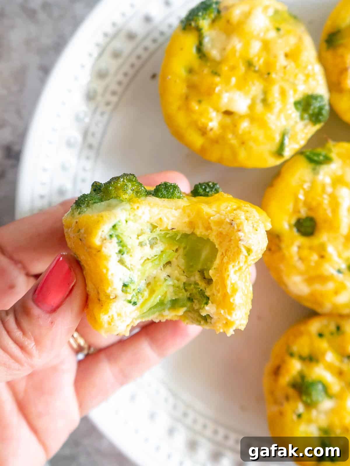 A bite taken out of a broccoli cheddar egg bite.
