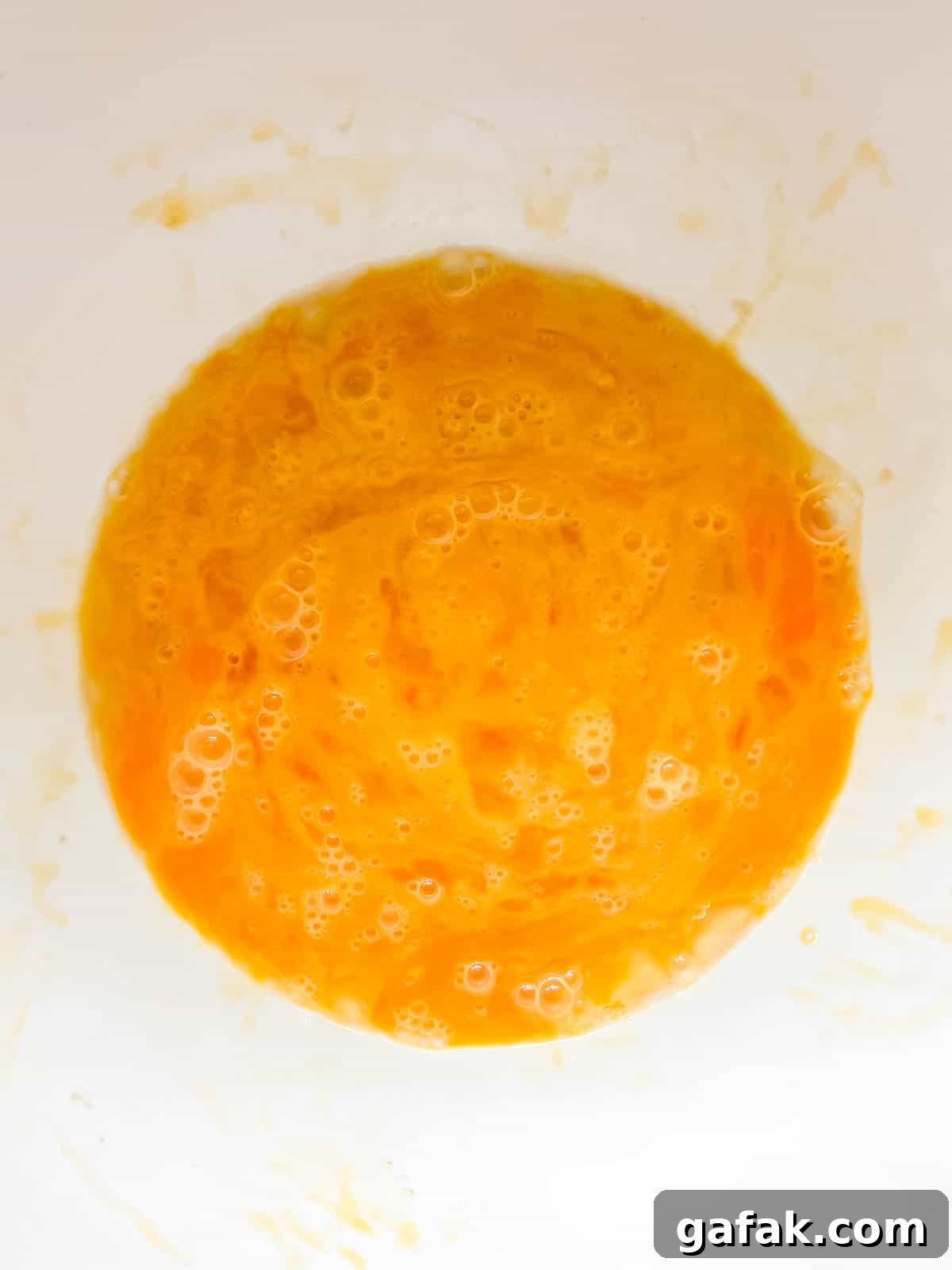 Eggs mixed together in a bowl.