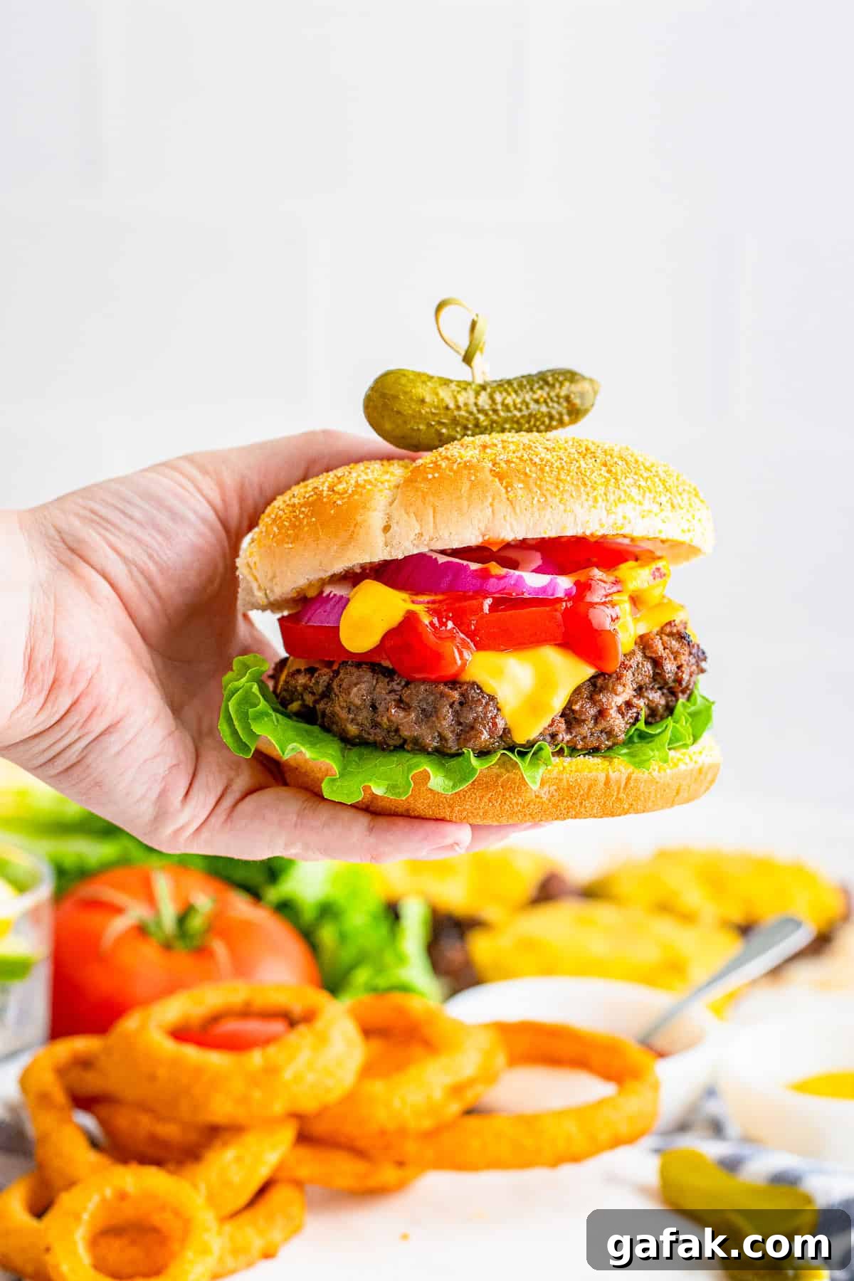 Hand holding Cheeseburgere