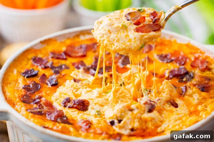 A spoonful of very cheesy Buffalo crack chicken dip.