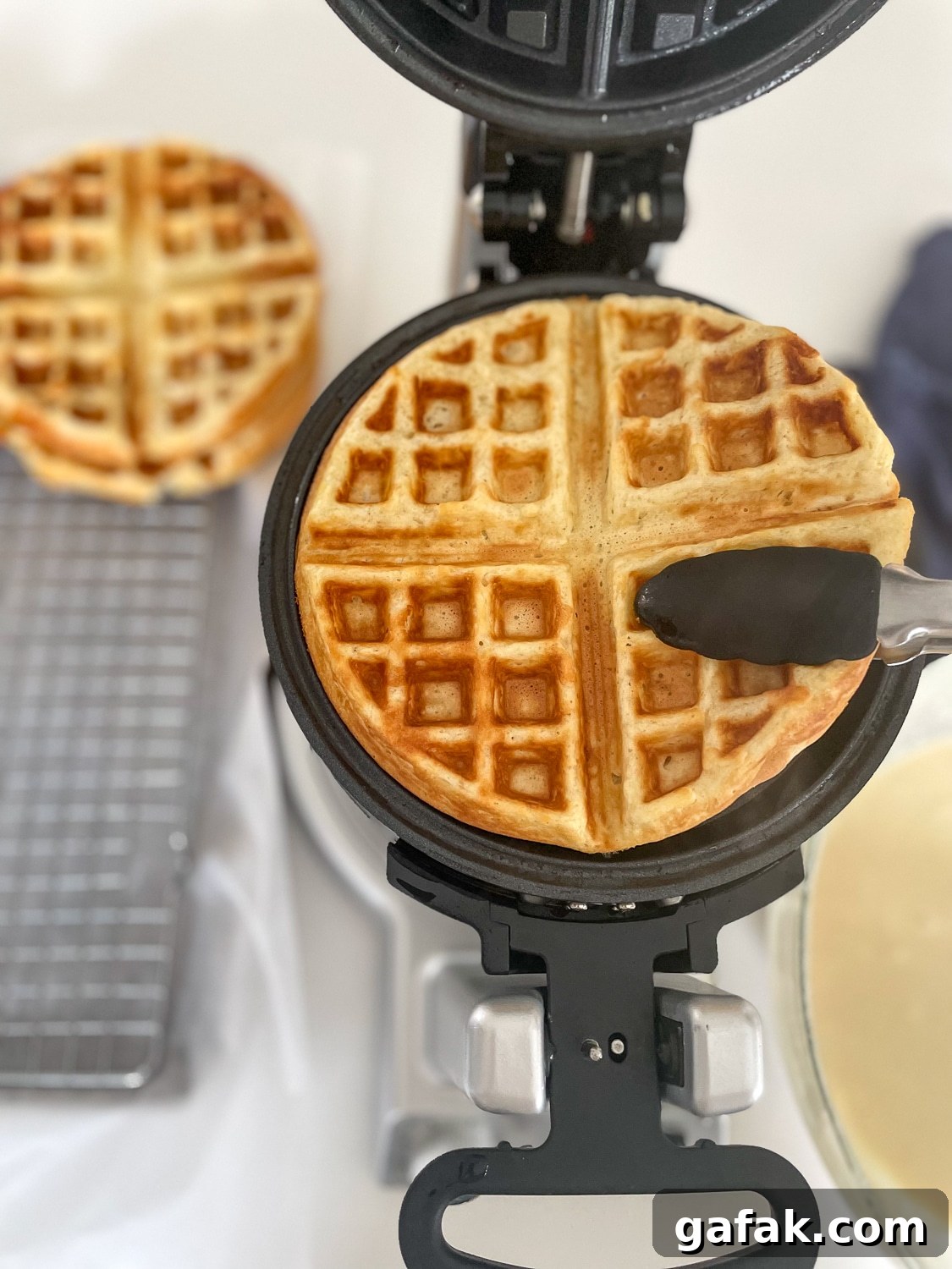finished waffle being taken out of the waffle iron
