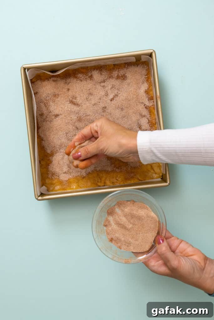 sprinkling cinnamon sugar on blondie batter