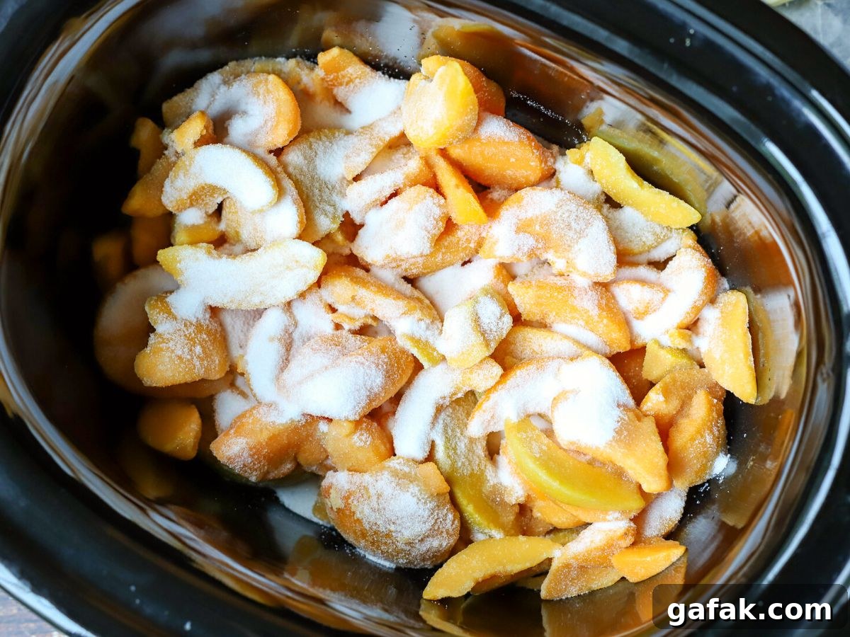 peaches and sugar in a crock pot.